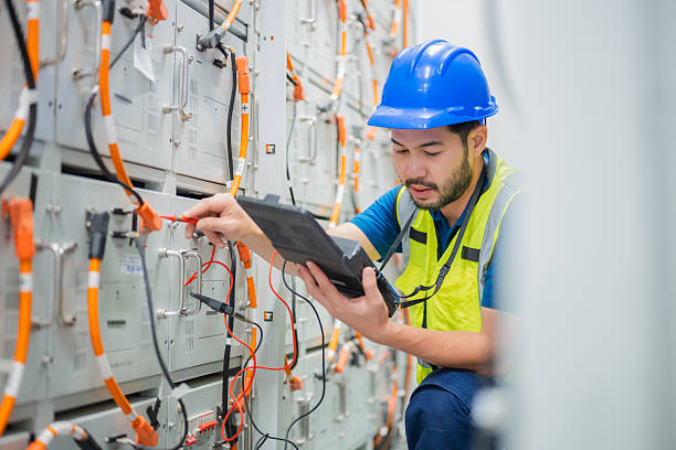 Professional electrician performing a safety inspection on a modern electrical panel